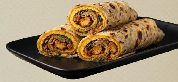 Chicken rolls on a black plate